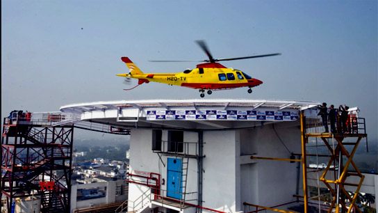A helicopter lands on the rooftop helipad of India’s first private hospital